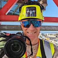 Nicholas up a crane with Salthill in the background